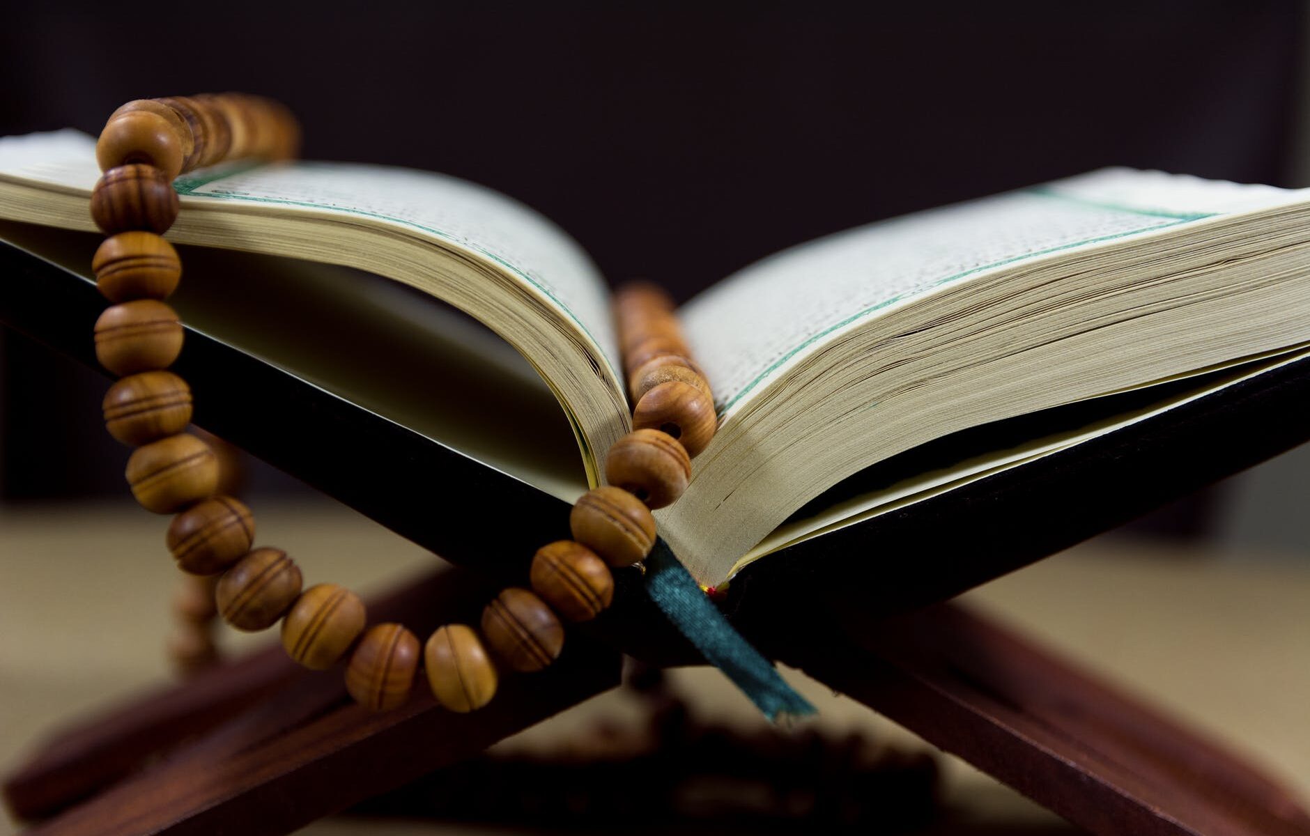 close up shot of prayer beads on a book